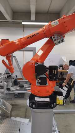 KUKA industrial robot in automation cell